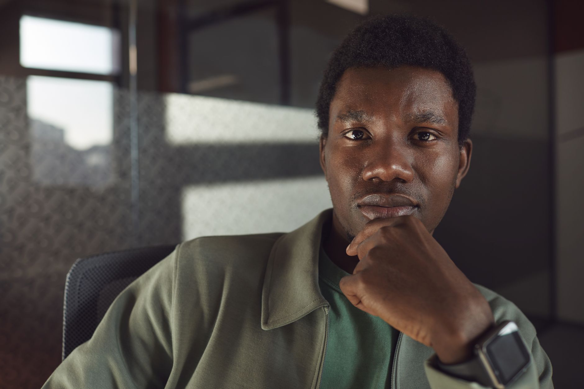 Portrait of a thoughtful businessman posed indoors, exuding confidence and contemplation.